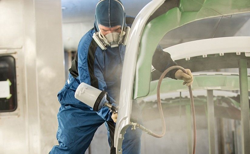 Mechanic painting a vehicle